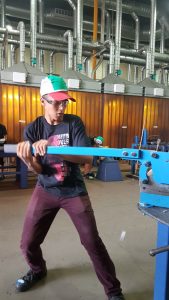 Young male high school student works in training facility.