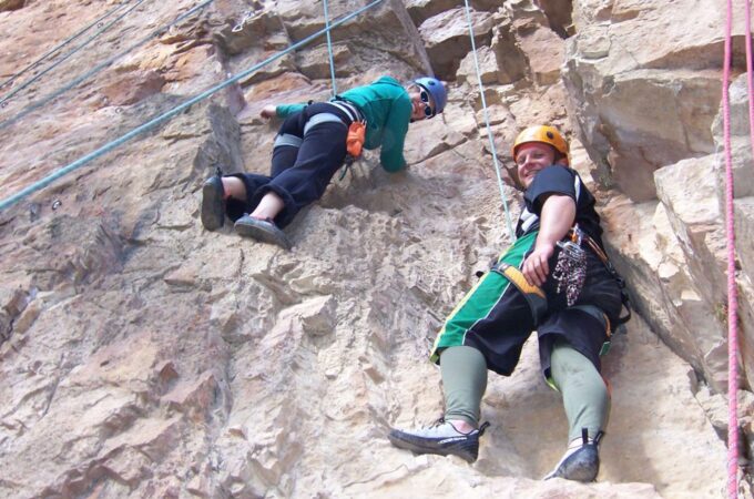 Two ATBO students scaling a mountain.