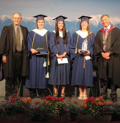 Image of College Board Chair Dave Handy and President and CEO David Walls with three academic award winners during graduation ceremony.