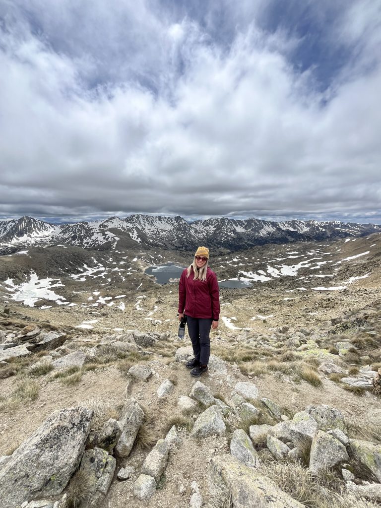 Female posing on rocky mountainous area in Andorra