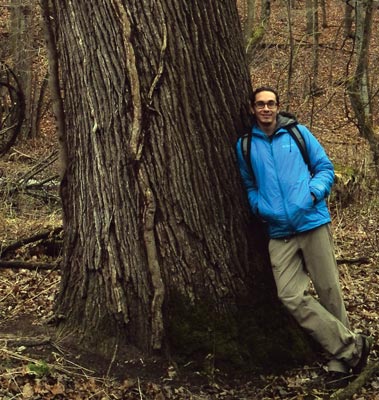 Image of Aboriginal Education Coordinator, Andrew Judge, leaning against a large tree.