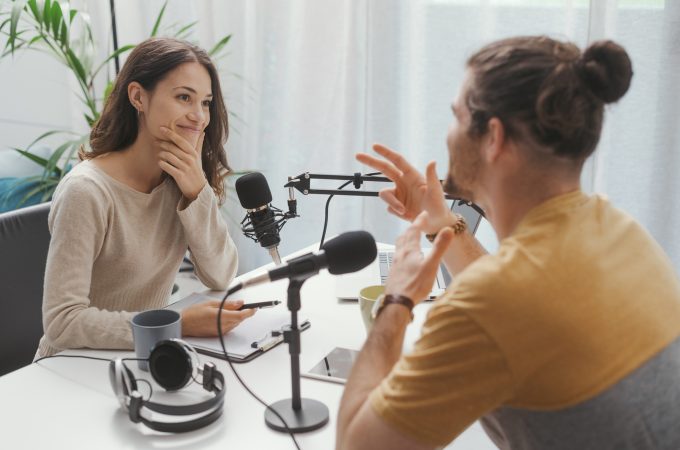 Young professional speaker conducting a live podcast interview, communication and media concept