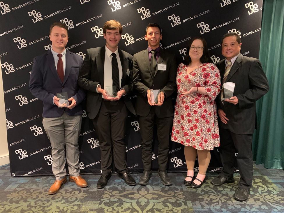 A group of students being presented an award at the Western Canada Business Competition.