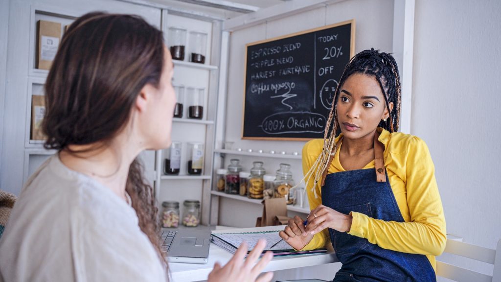 Latin woman recruiting personnel for her coffee shop.