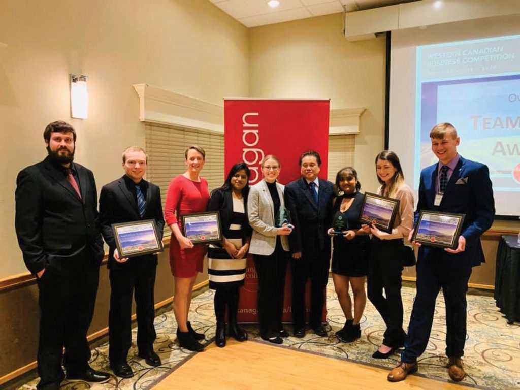 A group of students being presented an award at the Western Canada Business Competition.