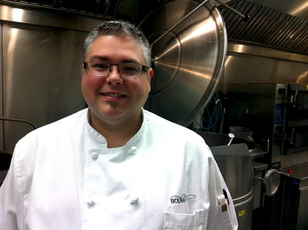 Image of man with glasses wearing a white chef's coat.