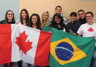 Image of students from Brazil holding Brazilian and Canadian flags.