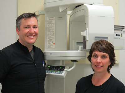 Image of Dr. David Burwash and Norma Sherret, Acting Department Head in front of new panoramic x-ray machine