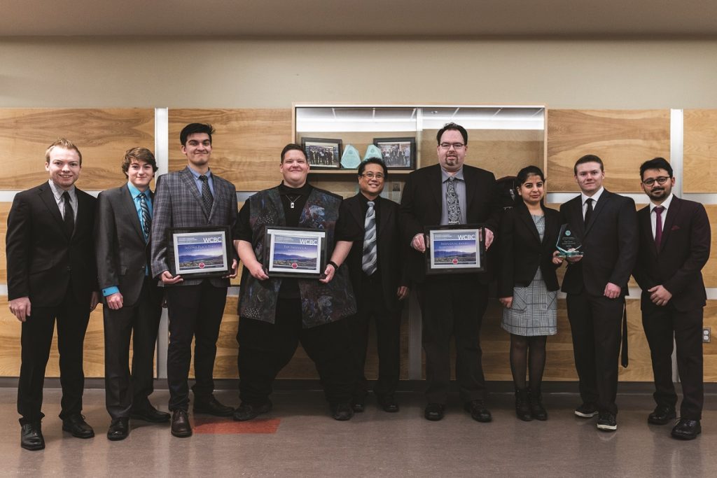 A group of students being presented an award at the Western Canada Business Competition.