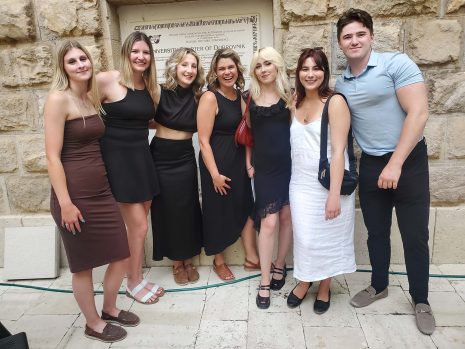 Image shows 6 women and one male standing in front of the University of Dubrovnik in Croatia.