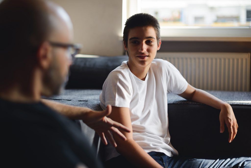 Social Worker talking with young boy.