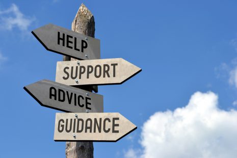 Image shows signpost with signs pointing to help, support, advice, and guidance