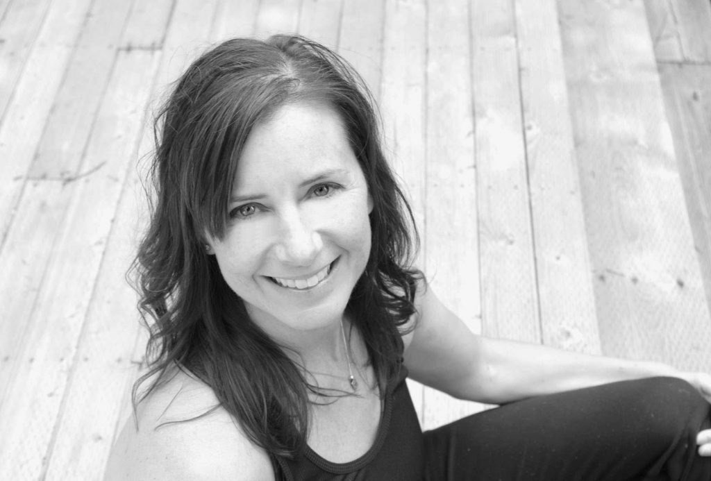 Blacka and white image of dark-haired woman smiling.