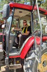 Co-op student in PPE driving a big machine.