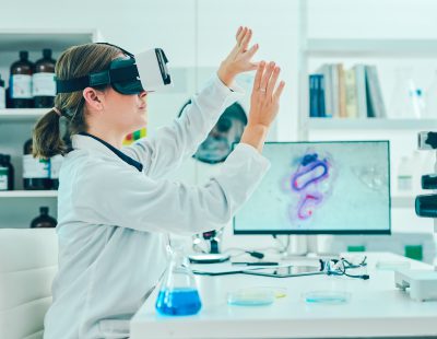 Image of a scientist using a virtual reality headset while conducting research in a laboratory.