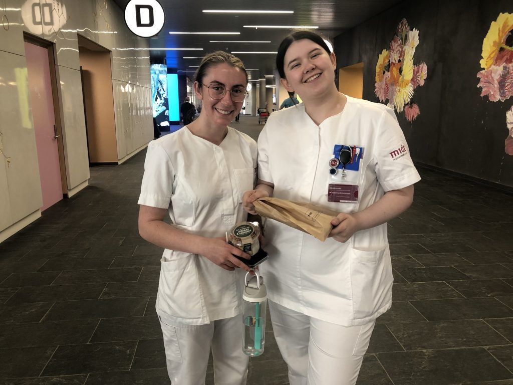 Two nursing students in a training hospital in Denmark. Students are smiling.