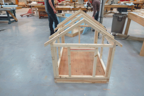 Image shows a dog house being constructed.