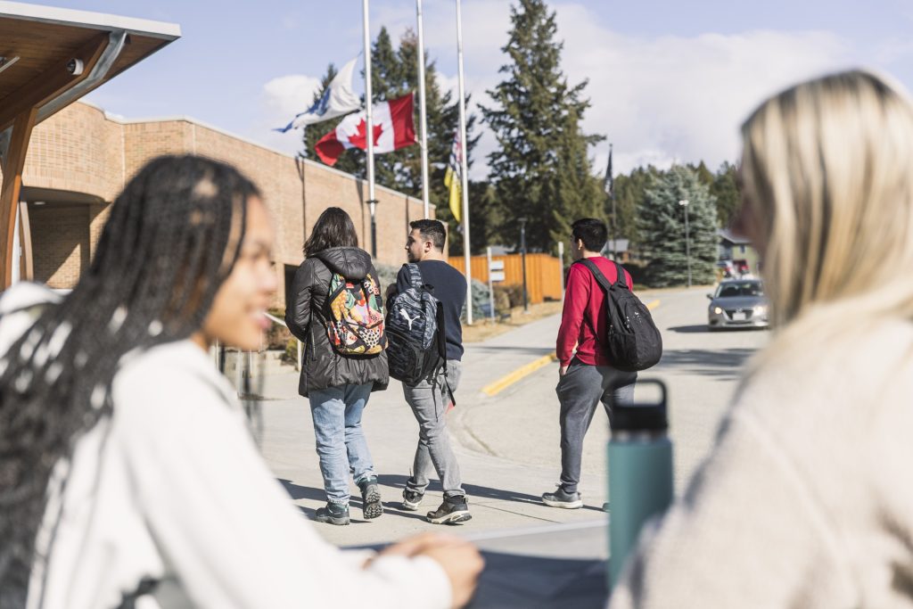 Students chatting outside entrance of College of the Rockies
