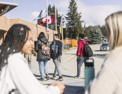 Students chatting outside entrance of College of the Rockies