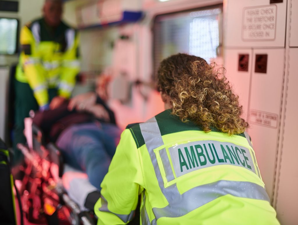 ambulance paramedics with casualty inside ambulance