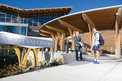 Image of two students standing outside College of the Rockies' Kootenay Centre entrance.