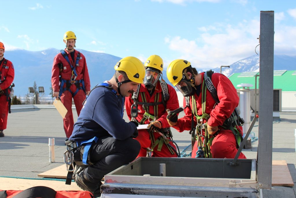 Fire Training Certificate students examining roof entryway.
