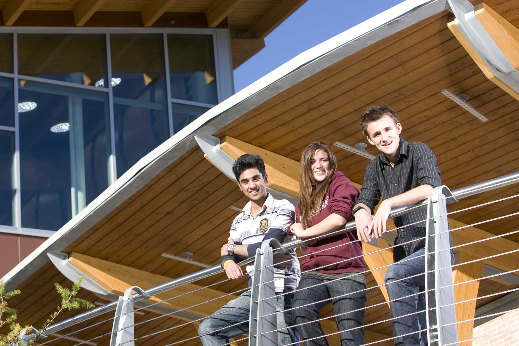 an image of three students standing outside the Cranbrook campus.