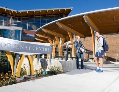 Two students chatting outside Kootenay Centre at College of the Rockies.