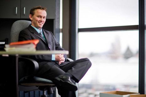 Image of man in suit in an office.