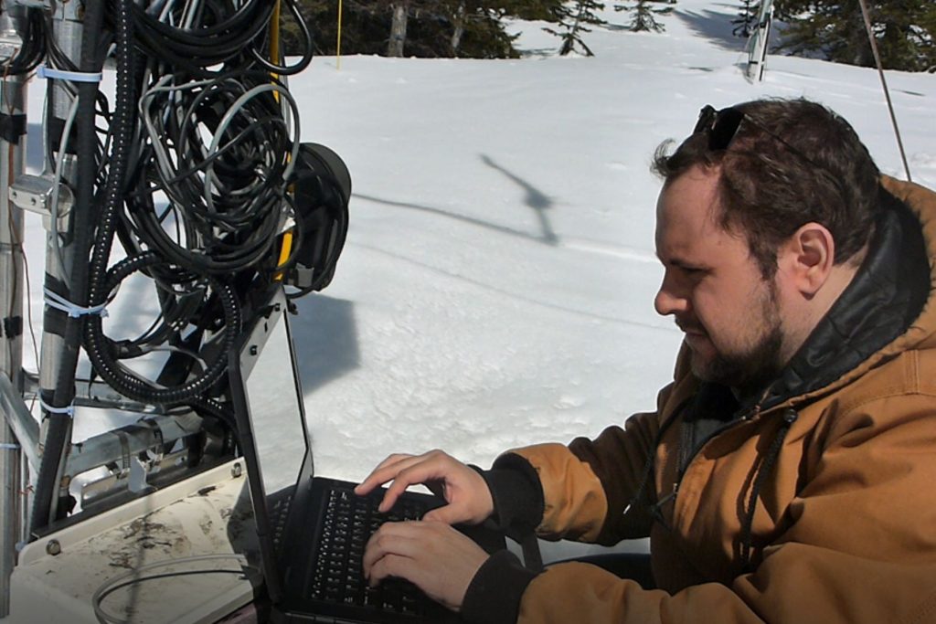 College instructor handling Geographic Info Systems equipment.