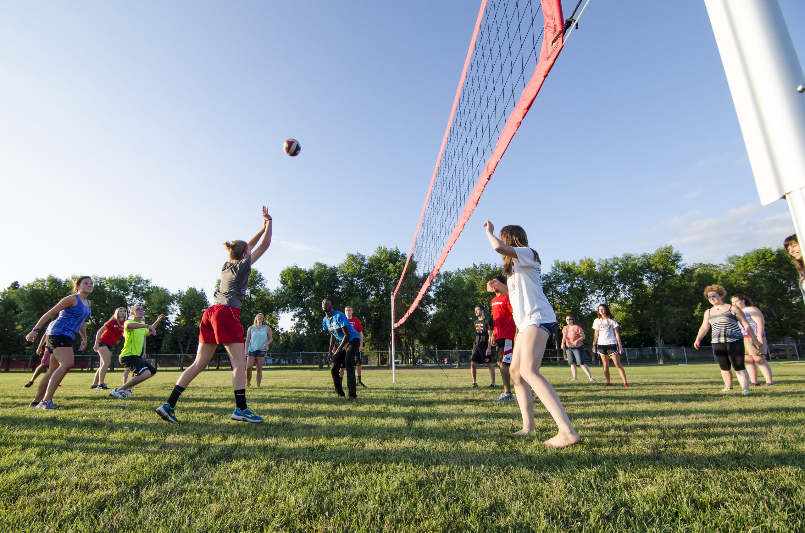 An image of several students playing volleyball.