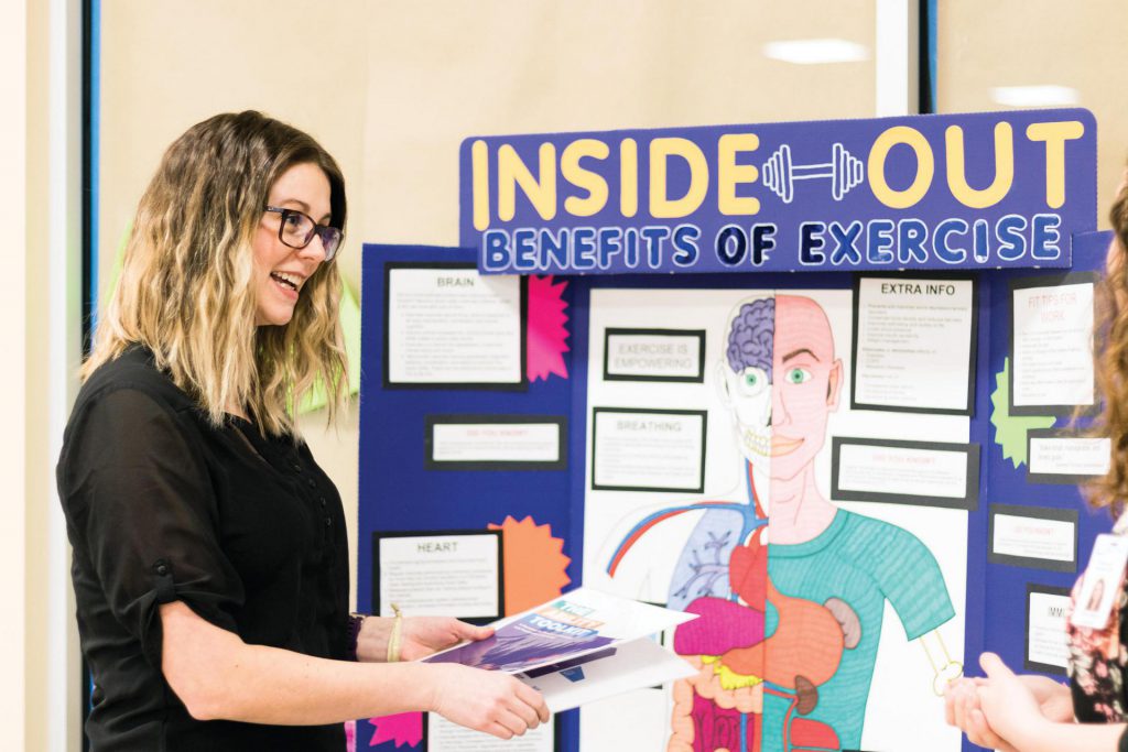 Image of young female nursing student standing in front of a display.