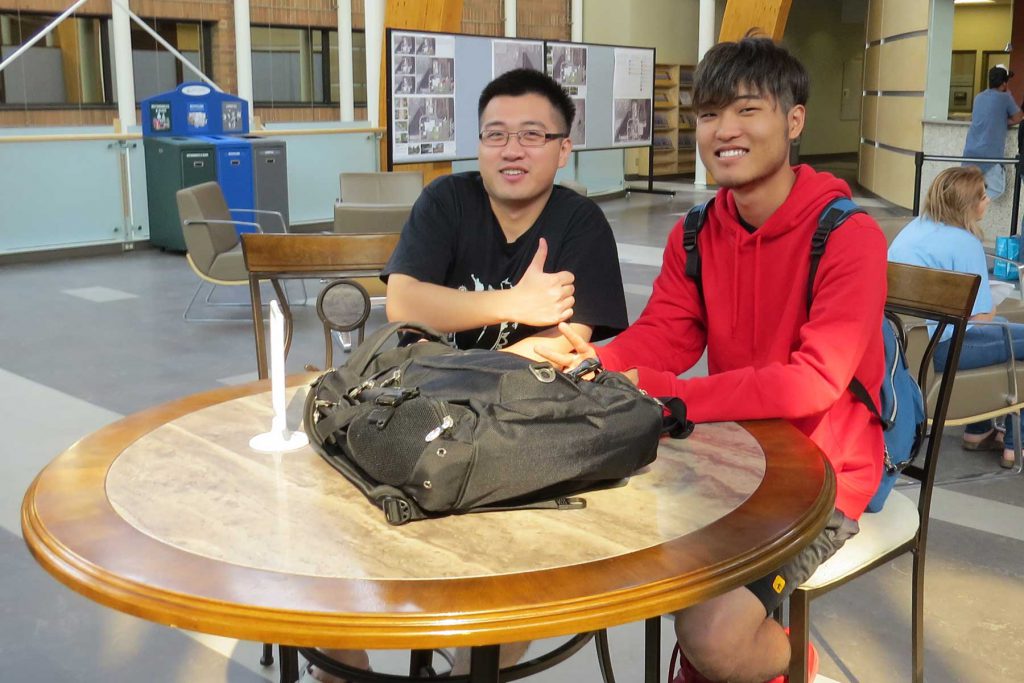 An image of two international students sitting at a table.