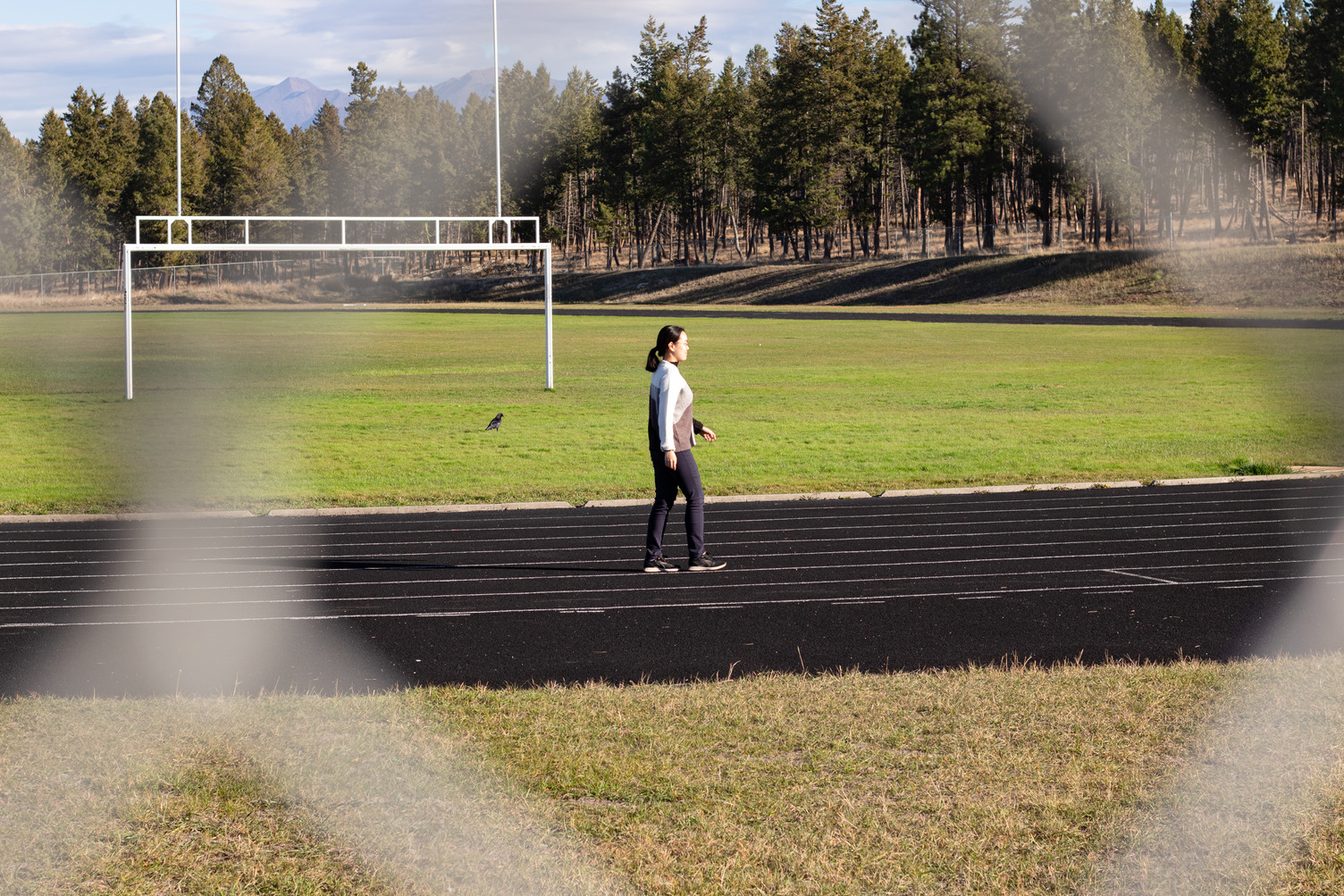 Female walking on track outside COTR