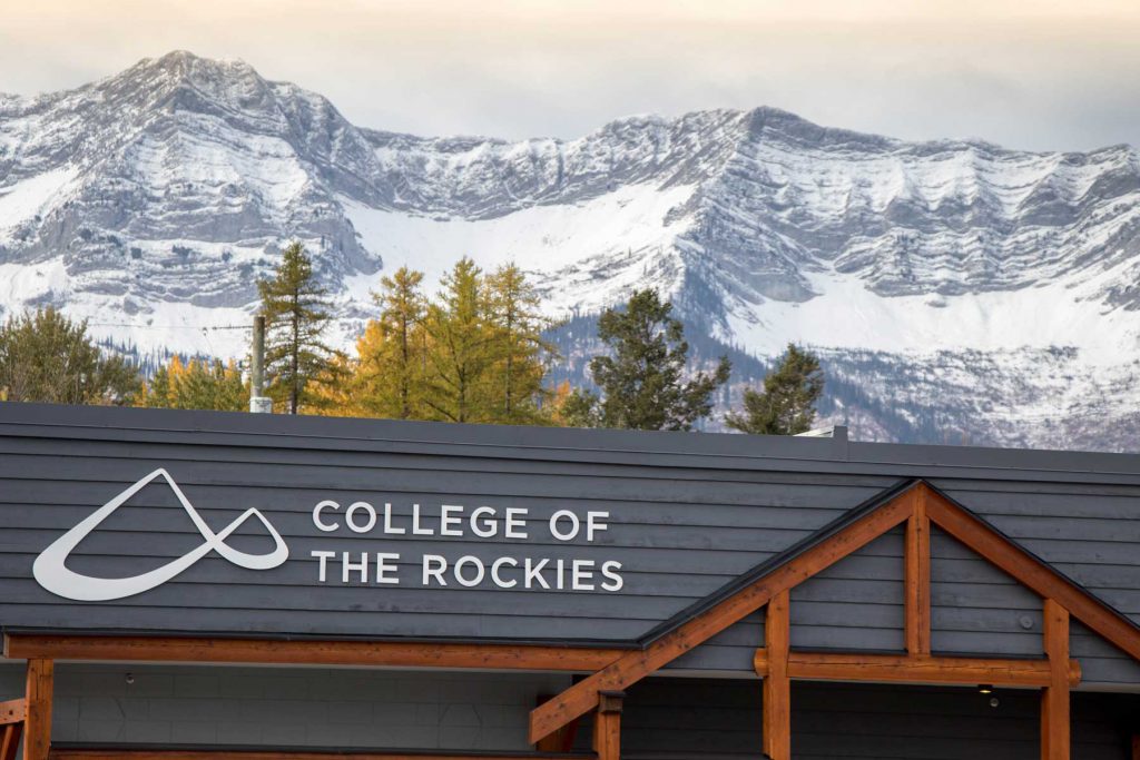 An image of the Fernie campus signage with college logo and moutains in the background.