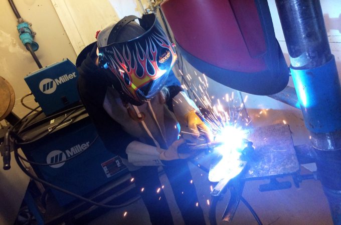 Welding student using welder equipment.