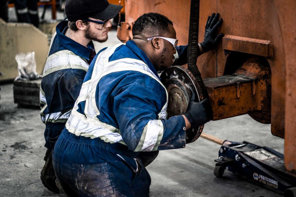 Heavy Mechanical Foundation students working on piece of equipment