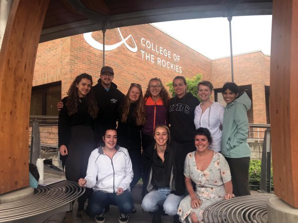 Image shows group of 10 individuals outside College of the Rockies main entrance