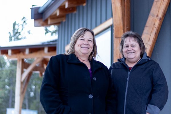 Image shows two women smiling outside College of the Rockies' Aboriginal Gathering Place