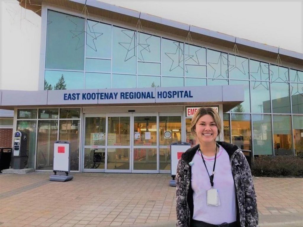 Image of Karly Flannigan standing in front of East Kootenay Regional Hospital