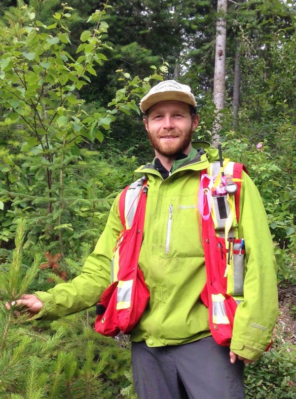 Image of man in high-vis gear out in forest.
