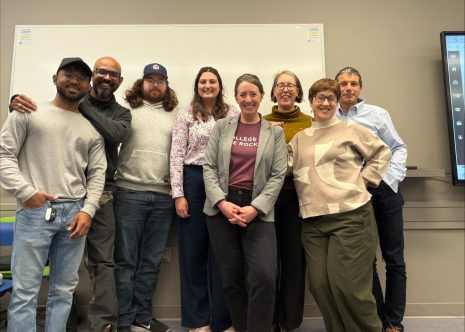 Image shows group of students and pitch competition judges.