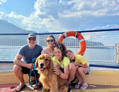 A family of four with their dog aboard a ferry on Kootenay Lake.