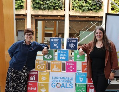 Image shows two College of the Rockies faculty members leaning on blocks describing the UN Sustainable Development Goals