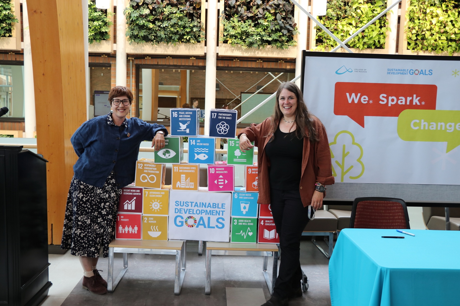 Two College of the Rockies faculty members leaning on blocks describing the UN Sustainable Development Goals