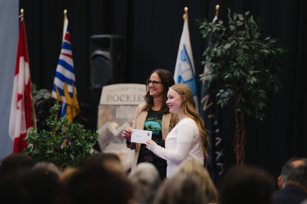 Presenter and recipient with a cheque at Scholarship & Awards