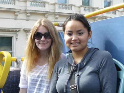 Image of two College of the Rockies students on top of a double-decker bus in London.