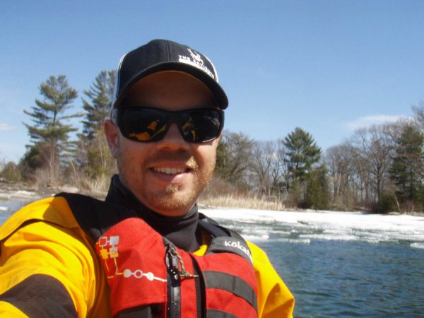 Image of man in lifejacket kayaking.