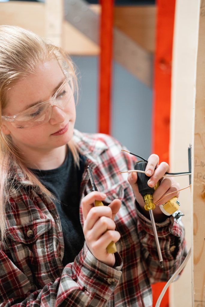 Female Electrical student working on project