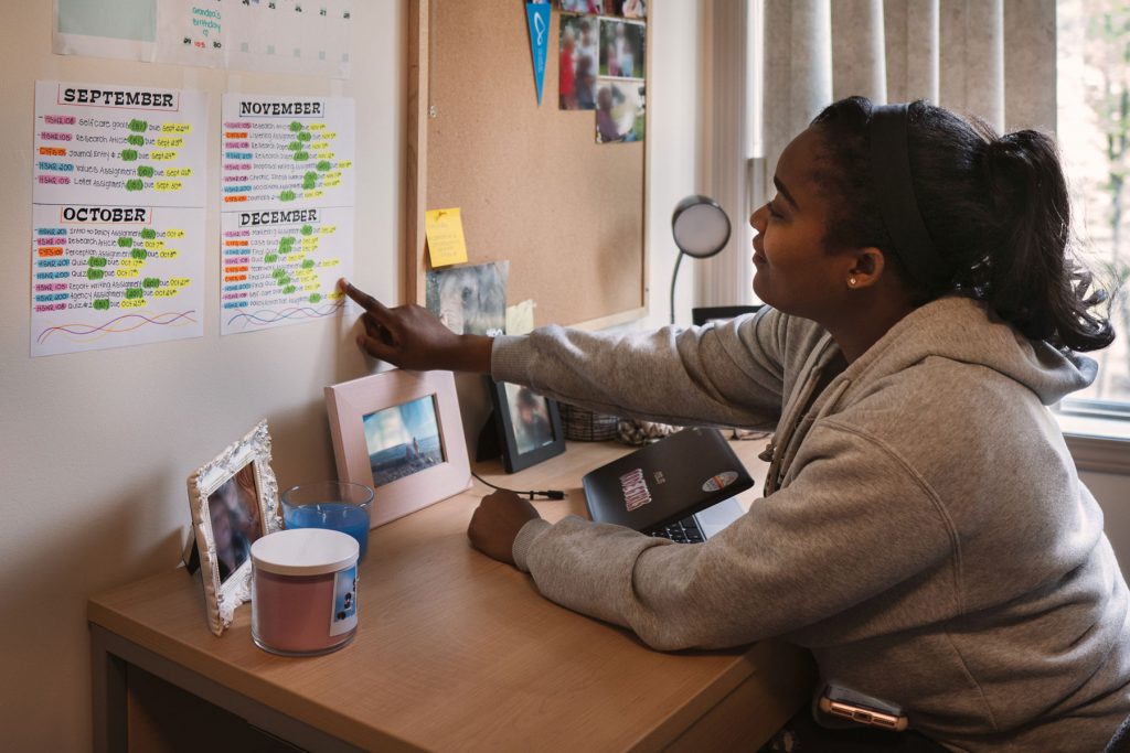 An image of a student sitting at a desk in Purcell House located at College of the Rockies.